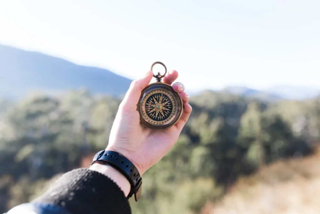 Traveller holding a compass in his hand