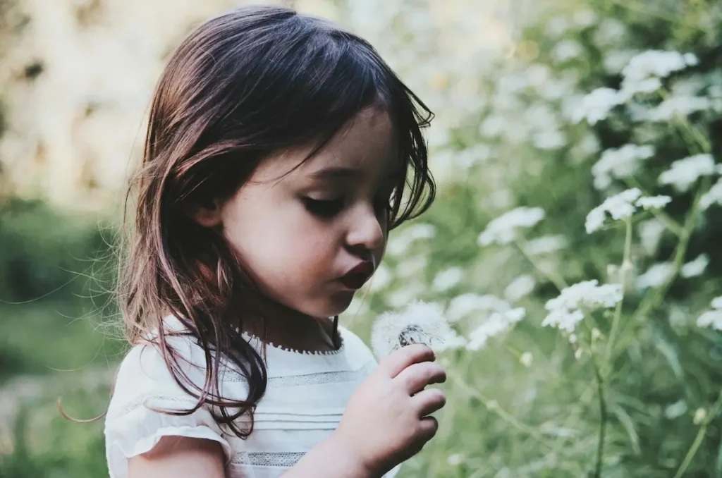 Little girl strolling through a garden