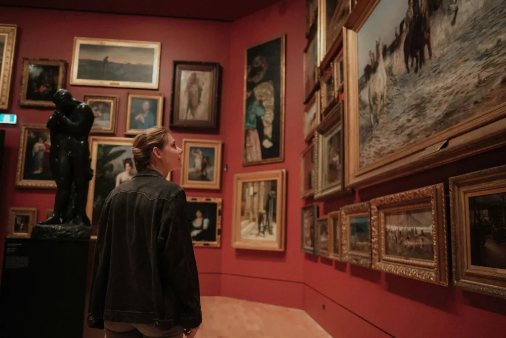 Woman visiting a museum and admiring a painting - culture against eco-anxiety