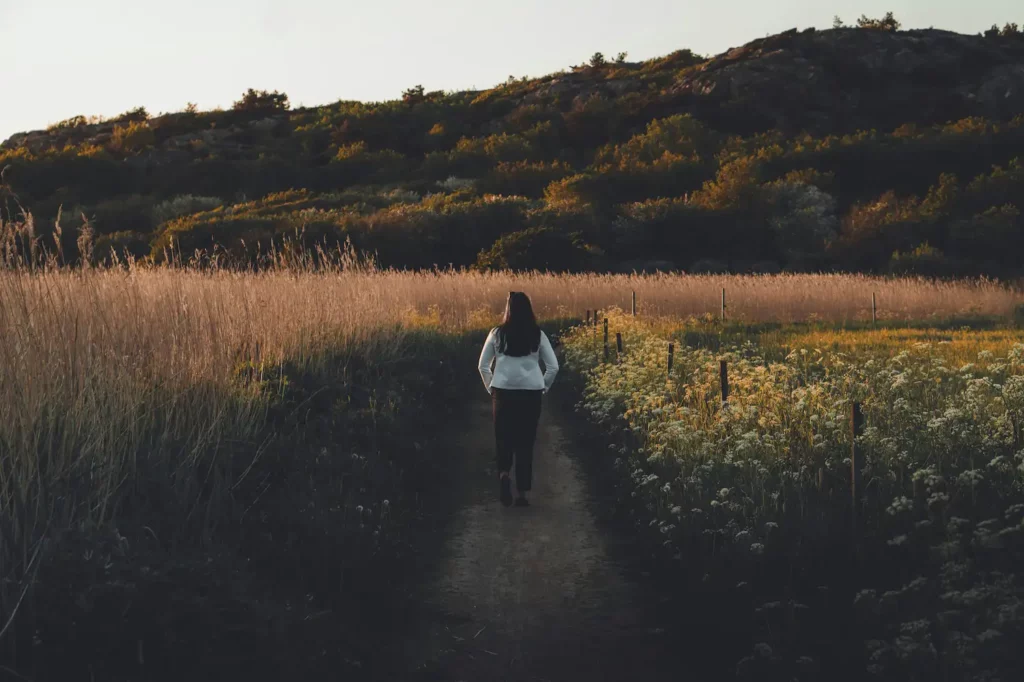 Young woman walking in nature - another way to deal with eco-anxiety